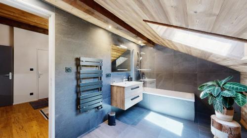 a bathroom with a sink and a bath tub at Nouveau ! Chalet pied des pistes in Champagny-en-Vanoise