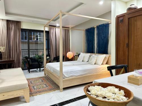 a bedroom with a canopy bed in a room at Dahlia Homestay Tay Ho in Hanoi
