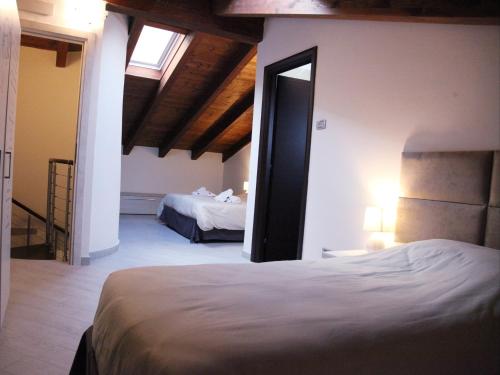 a bedroom with two beds and a mirror in it at RB Della Torre in Porretta Terme