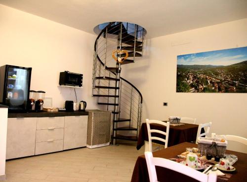 a kitchen with a spiral staircase in a room at RB Della Torre in Porretta Terme