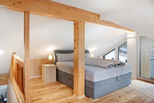 a bedroom with a bed with a wooden frame at Apartement Bens Auszeit Top 5 in Umhausen