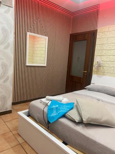 a room with a bed with a blue sign on it at b&b ERCOLANO Scavi in Ercolano