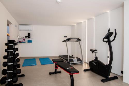 a gym with two exercise bikes and a treadmill at Ventus Villa - A Luxury Sea View Retreat in Akrotiri in Akrotiri