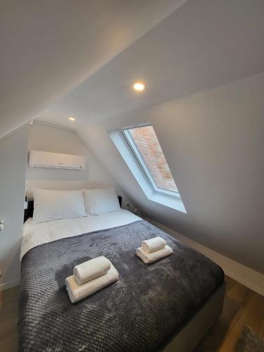 a bedroom with a bed with two towels on it at Studio apartman Mia in Zagreb