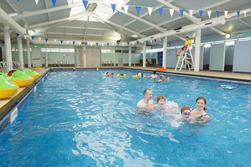 a group of people in a swimming pool at Let's Caravan at Whitley Bay in Whitley Bay