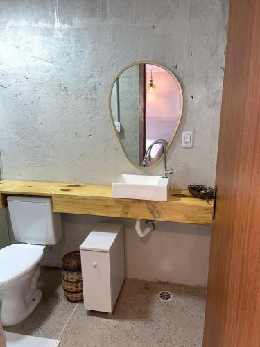 a bathroom with a sink and a mirror at NOAH Rústico Hotel in Bôca da Mata