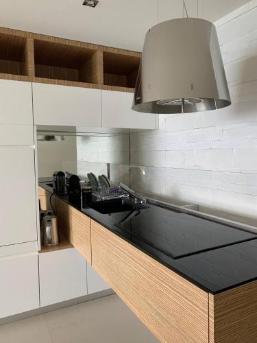 une cuisine avec des armoires blanches et un évier dans l'établissement Ô Béatrice Croisette, à Cannes