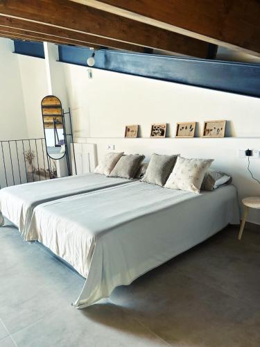 a large white bed in a white room at CASA ALKAPEPE in Ontur