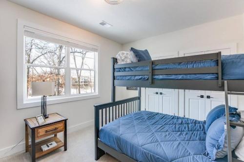 a bedroom with two bunk beds and a window at Luxury Estate with Stadium TDJ Views Sleeps 20 in South Bend