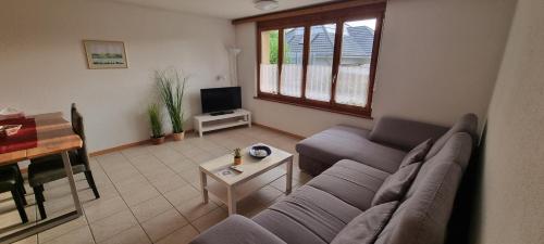 a living room with a couch and a table at Ruheort in Beinwil