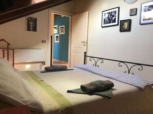 a bedroom with two beds with pillows on them at da nonna Emi in Modena