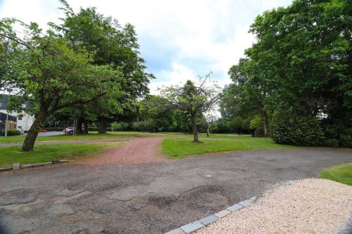 a dirt road in a park with trees at Woodhead view in Kirkintilloch