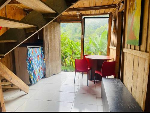 a room with a table and chairs and a window at Cabaña y temazcal Mastai in Jardin
