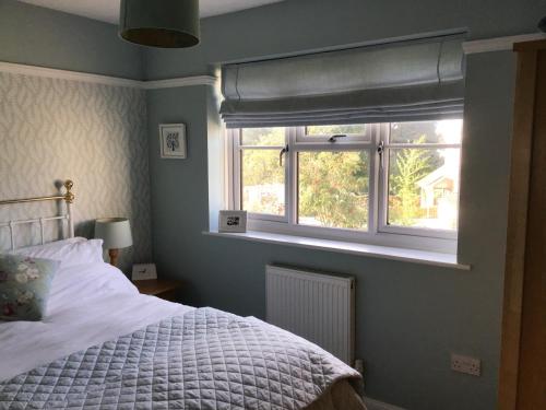 a bedroom with a bed and a window at A place to stay in Stoke Gifford in Bristol