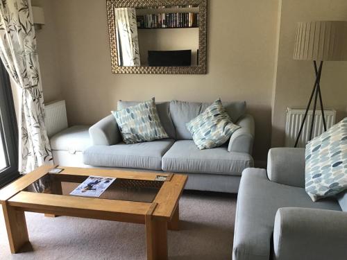 a living room with a couch and a coffee table at A place to stay in Stoke Gifford - Parkway train station 5 min walk in Bristol