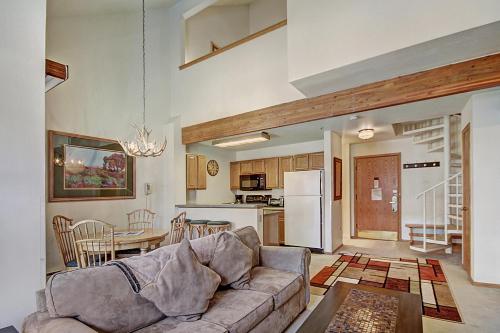a living room and kitchen with a couch and a table at River Mountain Lodge, A Vail Resorts Property in Breckenridge