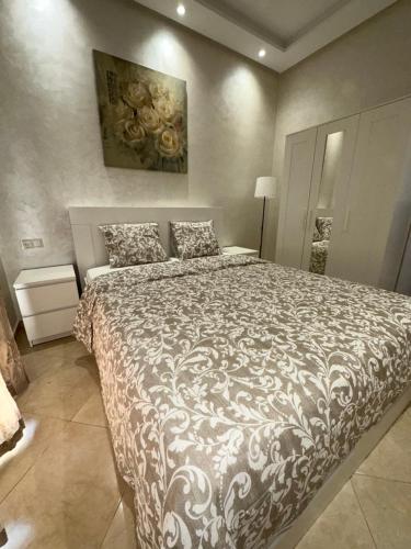 a bedroom with a large bed with a comforter at Apparemment de luxe Bouznika in Bouznika