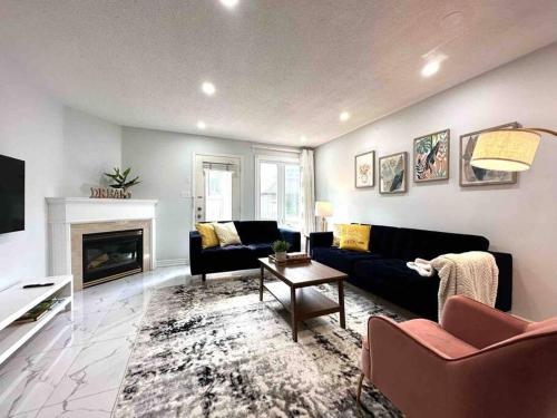 a living room with a couch and a fireplace at Charming Home in Prime Location North of Toronto in Richmond Hill