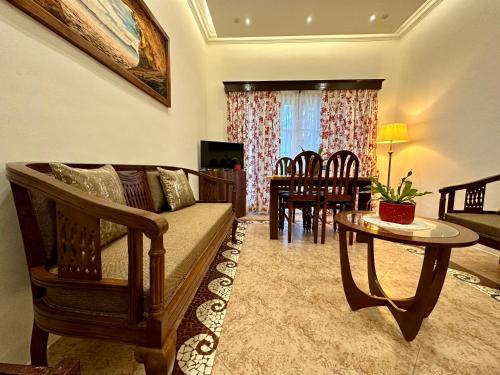 a living room with a couch and a table at Nestwood - By The Beach Goa in Benaulim
