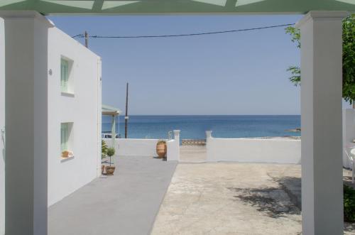 a white house with a view of the ocean at Georgias House in Skiros
