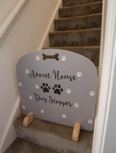 a dogstar house dog stroller on the stairs at Avocet House Hunstanton 250m from the sea in Hunstanton