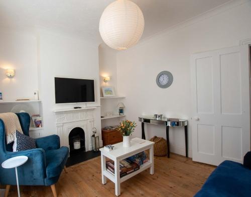 a living room with a fireplace and a tv at Avocet House Hunstanton 250m from the sea in Hunstanton