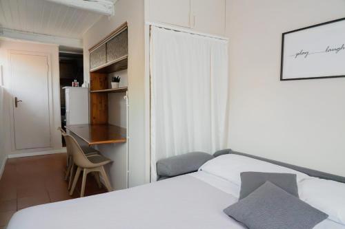 a bedroom with a bed and a desk and a kitchen at Torre al Serraglio in Prato
