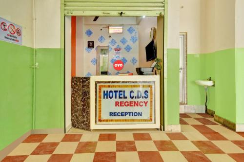 a hotel lobby with a sign in a room at OYO Flagship Hotel CDS Regency in Patna