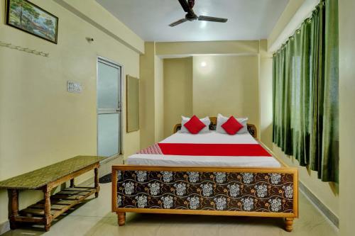 a bedroom with a large bed with red pillows at OYO Flagship Hotel CDS Regency in Patna