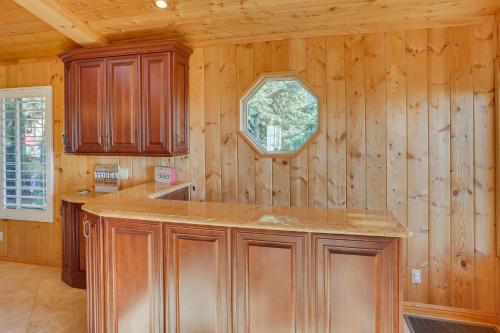 a kitchen with wooden walls and a counter top at Spacious Running Springs Home with Mountain Views in Running Springs
