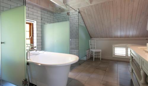 a bathroom with a tub and a sink at Andreas Country House in Wellington
