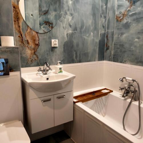 a bathroom with a sink and a toilet and a tub at Aleja N.M.P 73 in Częstochowa