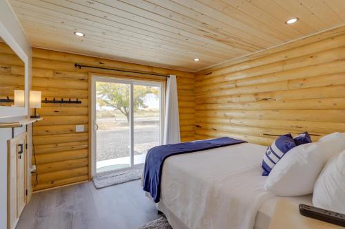 Cette cabane en rondins comprend un lit et une fenêtre. dans l'établissement Secluded Grand Junction Getaway with Sweeping Views!, à Fruita