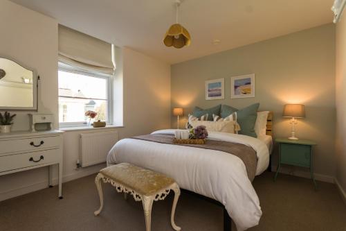 a bedroom with a large bed and a window at Stunning Sea View Central Torbay Home with Parking in Torquay