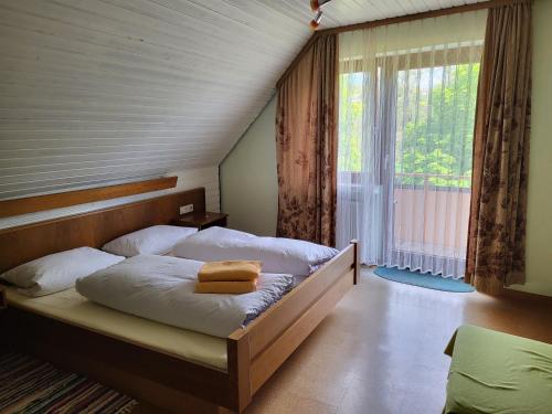 a bedroom with a bed with a large window at Hotel Krone in Tauberrettersheim