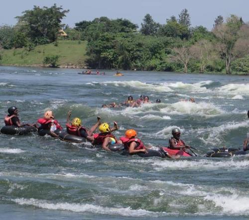 a group of people rafting in a river at Villa Karibu in Kampala