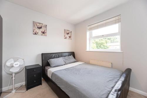 a bedroom with a bed and a window at En-suite Double Room (Private bathroom) Central London in London