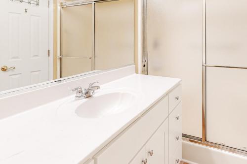 a white bathroom with a sink and a shower at Beaconhill Road 68 in Ocean Pines