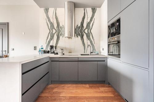 a white kitchen with a sink and a stove at Benesta Taksim No.8 in Istanbul
