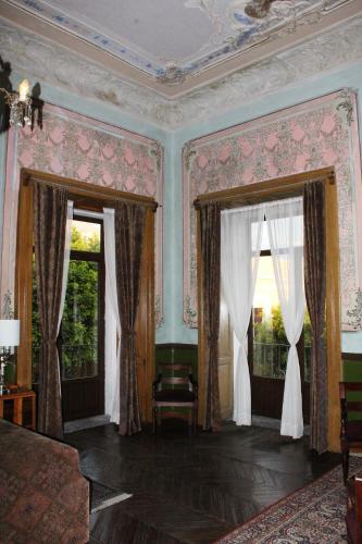 a room with two large windows with curtains at Hotel Boutique Casa de la Palma in Puebla