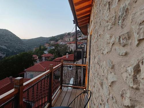 a balcony with a view of a city at Casagli Luxury Suites in Dhimitsana