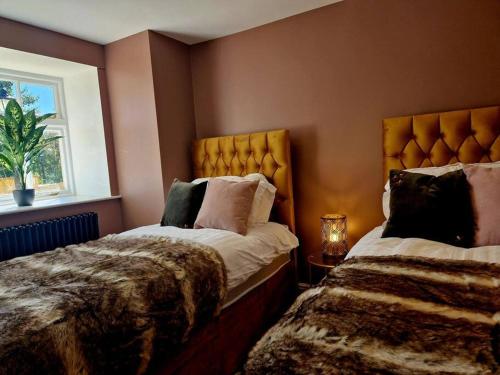 a bedroom with two beds and a window at The Hamilton Luxury Let-The Duke in Scorton