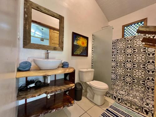 a bathroom with a sink and a toilet at Rinconcito Magico beachfront location in Punta Uva