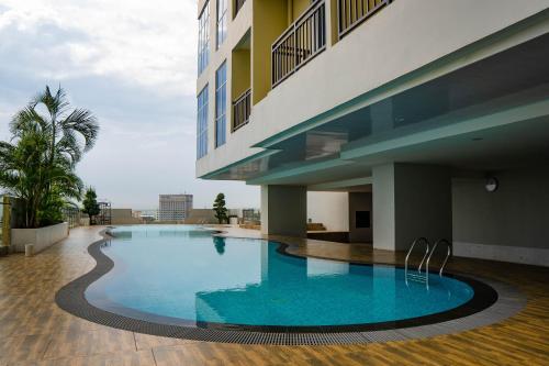 a large swimming pool next to a building at Formosa Spacious Apartments with Netflix & Pick Up Service by MESA in Nagoya