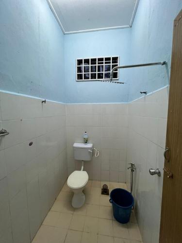 a bathroom with a toilet and a window at Relaxs Homestay Semi-D in Bachok
