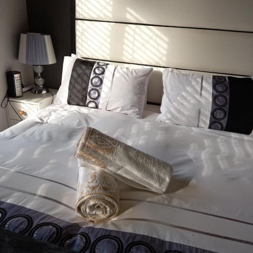 a white bed with a silver object on it at Crest Farm Cottage in Waterfall