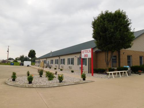 a building with a sign that reads hotel inn at Attica Inn in Attica