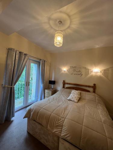 a bedroom with a large bed and a window at Stackhouse flat in Burnley