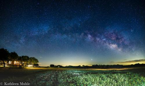 a starry night with the milky way over a field at Hickory Ridge Hideaway Cabin - Romantic, Peaceful in Llano