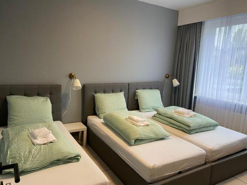dos camas sentadas una al lado de la otra en una habitación en Bnb Antwerp SportPlaza en Amberes